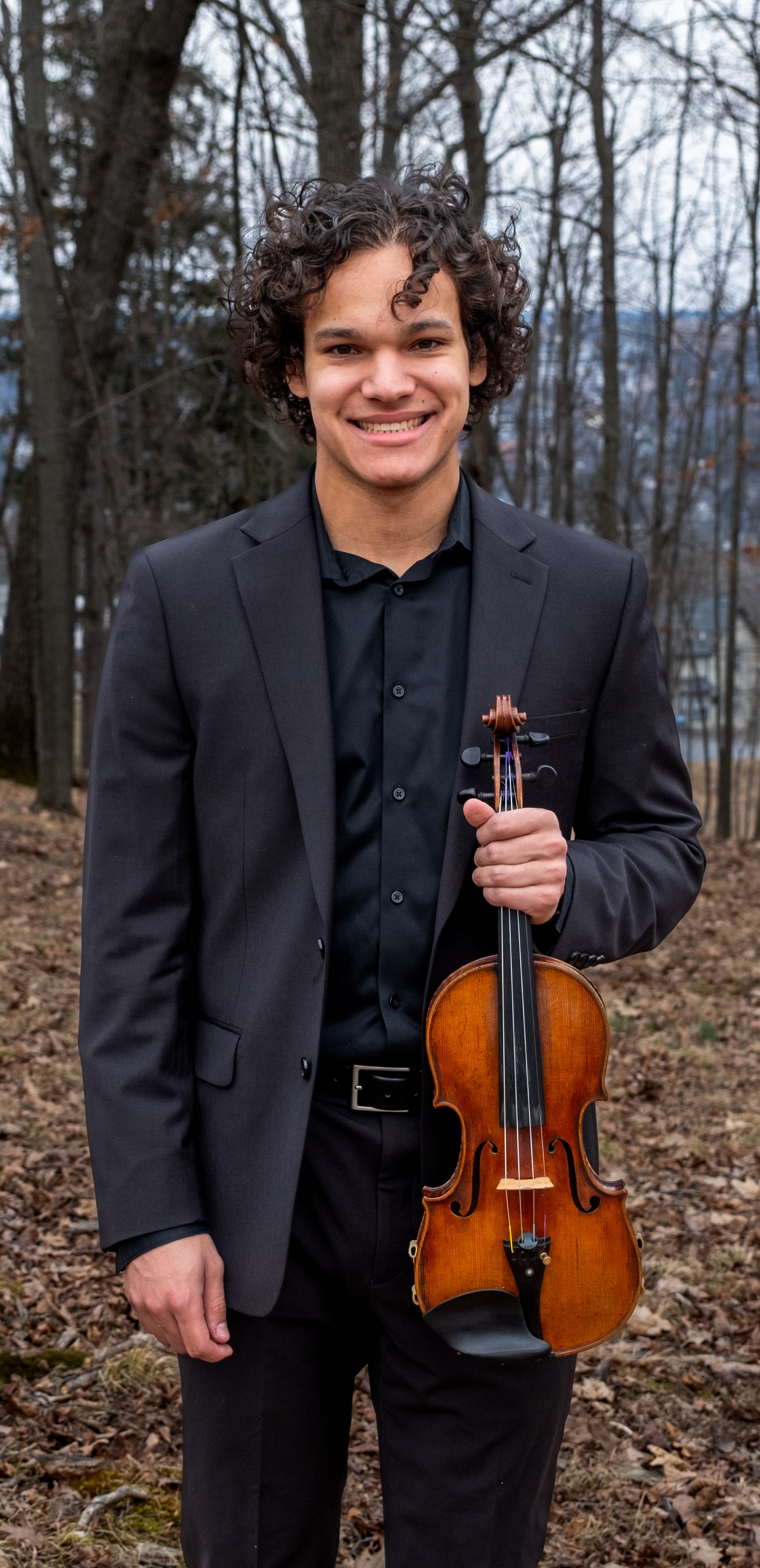 Kian holding his violin